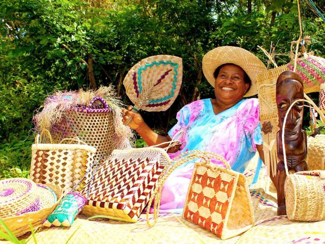 Smiling woman and her weaving (Vanuatu)