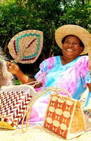Smiling woman and her weaving (Vanuatu)