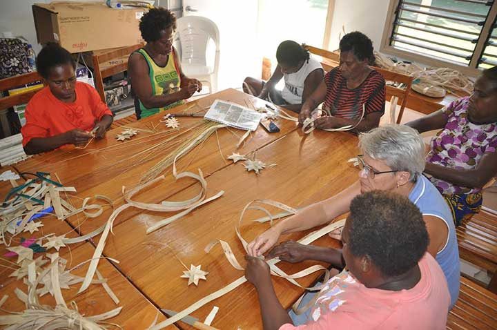 Pandanus weavers of Malekula learning to weave xmas decoration