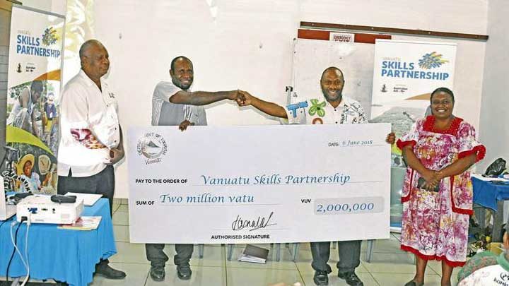 The Department of Tourism and Skills Partnership representatives holding a cheque